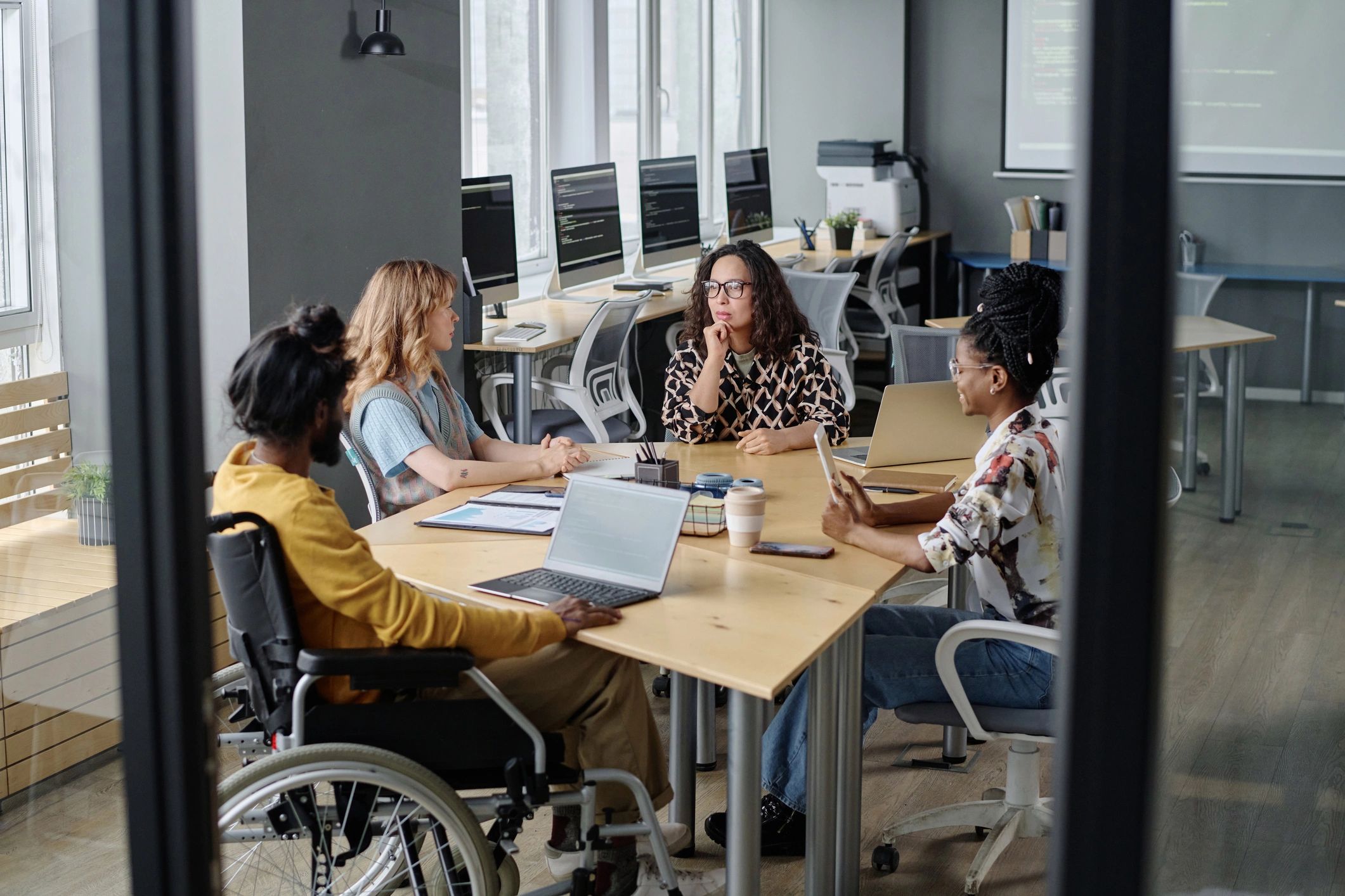 Amitech Group team collaborating in a modern workspace